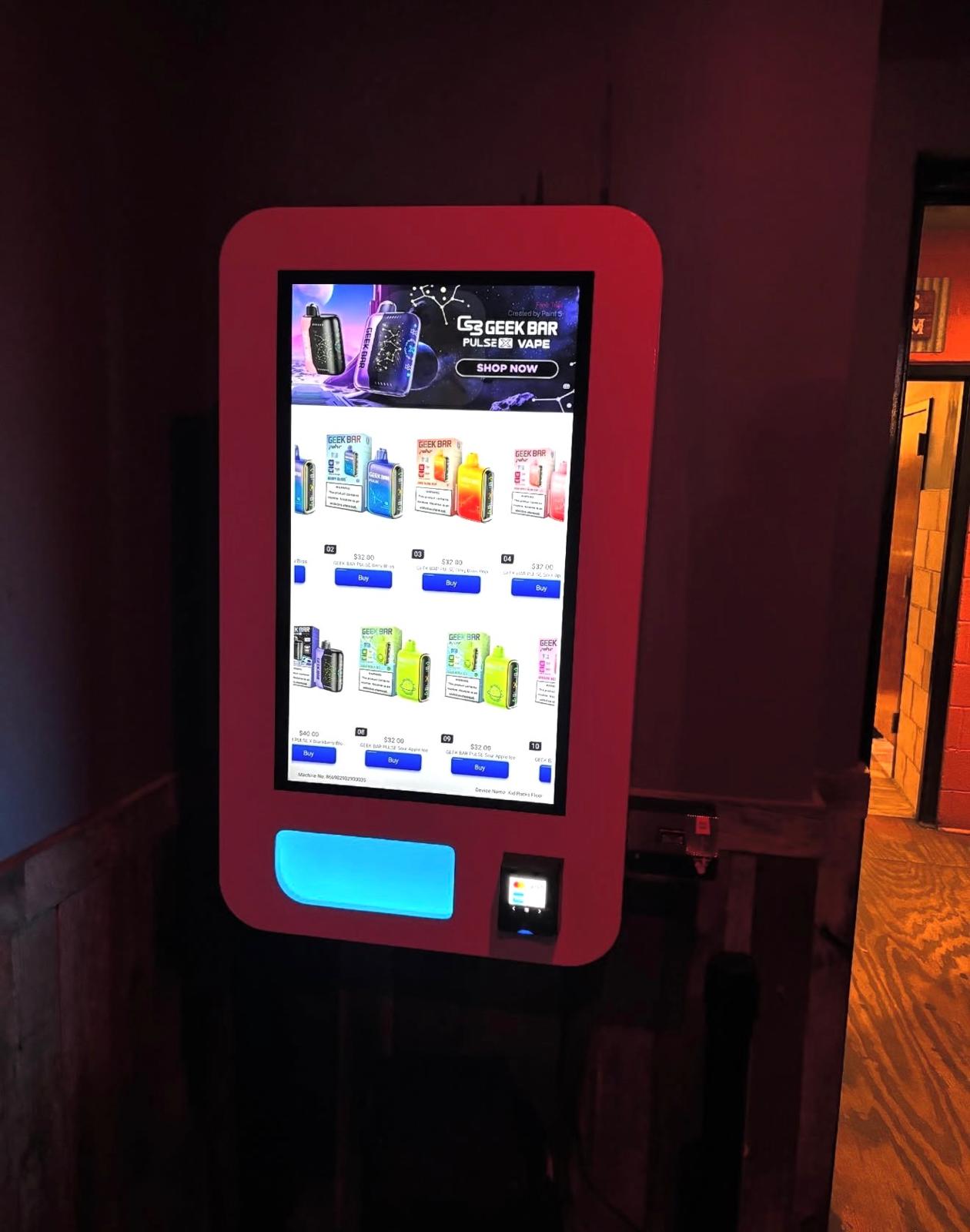 Red-wrapped vending machine in a dim bar hallway