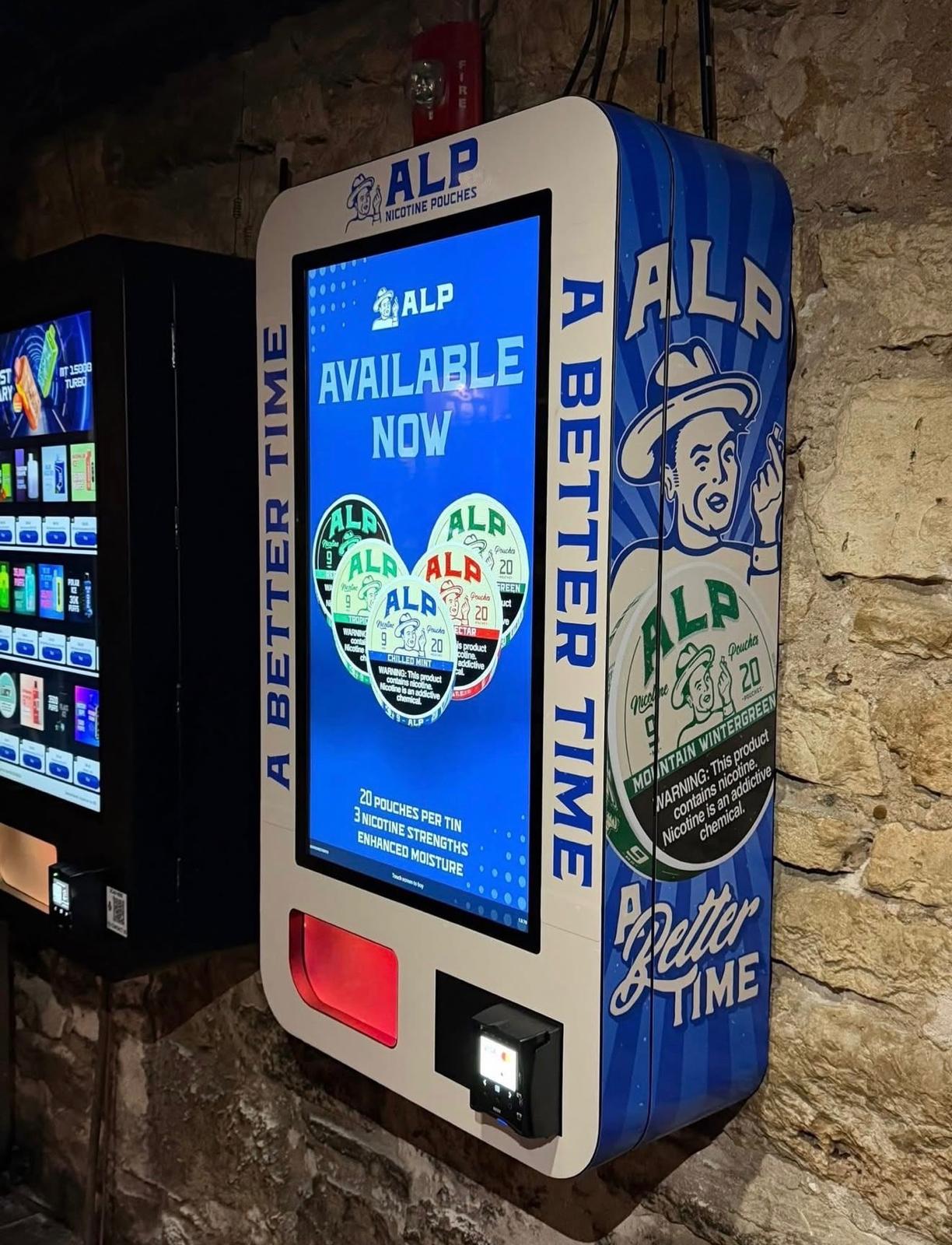 Custom-wrapped NiteStock vending machine mounted on a stone wall in a bar